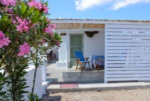a house with a blue chair on a patio at Errika's Sweet Home in Provatas