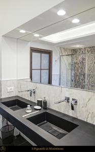 uma casa de banho com um lavatório e um espelho grande em Dimora Donna Elena by Ranieri em Nápoles