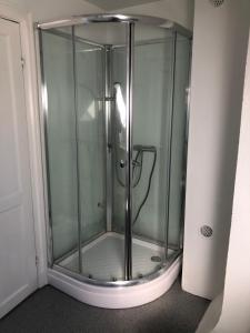 a shower with a glass enclosure in a room at Classic Brown Stone Apartment in Copenhagen