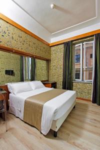 a bedroom with a large bed and a window at Hotel Arcangelo in Rome