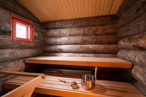 a wooden bench sitting next to a wooden wall at Kakslauttanen Arctic Resort - Igloos and Chalets in Saariselka