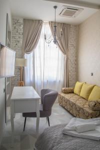 a living room with a couch and a table at Domestic House Lola in Vukovar