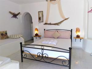 a bedroom with a bed with pink pillows on it at Errika's Sweet Home in Provatas