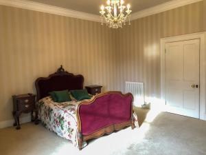 Ένα ή περισσότερα κρεβάτια σε δωμάτιο στο Netley Hall