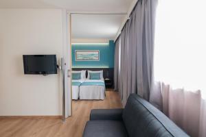 a living room with a bed and a couch at Aparthotel Atenea Barcelona in Barcelona