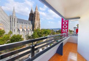 a balcony with a view of a cathedral at Aishwarya Le Royal in Mysore