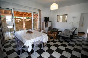 a living room with a table and a couch at Lovely house with Garden and Terrace very close to the beach in Hourtin