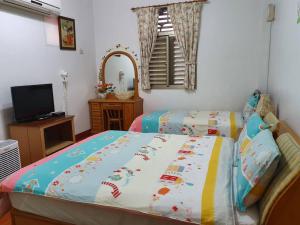 Posteľ alebo postele v izbe v ubytovaní Yilan Xiang Feng Homestay