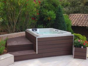 a hot tub sitting in the middle of a garden at Luxurious Holiday Home in Saint Rapha l with Jacuzzi in Saint-Raphaël