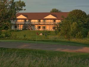 a large house on a hill with a golf course at Lake Panorama National Resort in Panora