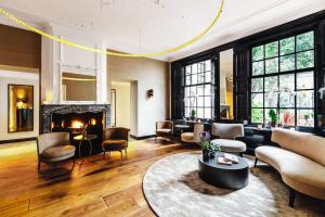 
a living room filled with furniture and a fire place at The Dylan Amsterdam - The Leading Hotels of the World in Amsterdam
