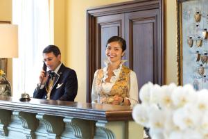 a man and a woman standing in front of a mirror at Airelles Gordes, La Bastide in Gordes