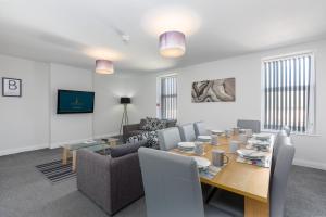 a living room with a table and a couch at Heritage House Apartments - Blackpool Resort Collection in Blackpool