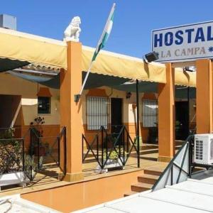a hospital building with a flag on top of it at Hostal la Campa in Chiclana de la Frontera +2 photos