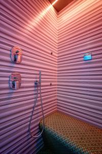 een badkamer met een roze muur met een slang bij Ara Suite in Rome