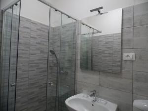 a bathroom with a shower, sink, and mirror at Appartamenti del Dose in Venice