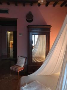a room with a bed and a dresser at La Locanda del Loggiato in Bagno Vignoni