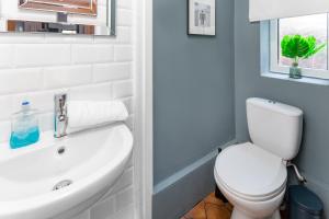 a bathroom with a white toilet and a sink at Air Host and Stay - Stanley House Large house, sleeps 10 5 mins to city centre in Liverpool
