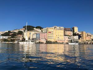 a view of a city from the water with boats at La Casa dei Sogni di Dory in Genoa