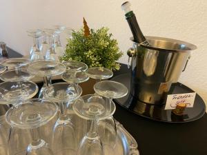 a bunch of wine glasses and a bucket with a bottle of wine at Berghotel HARZ in Hahnenklee-Bockswiese