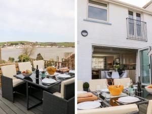 a patio with a table and chairs and a house at The Light House in Bideford