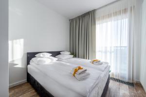 Postel nebo postele na pokoji v ubytování GO Apartments - ApartHotel