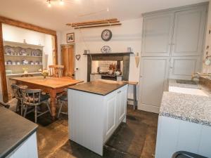 a kitchen with a table and a dining room at Home Farm in Boscastle