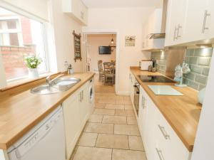 a kitchen with a sink and a counter at Hazelmere Cottage in Worksop