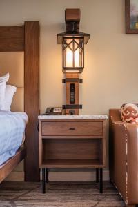 a bedroom with a bed and a lamp at High Peaks Resort in Lake Placid