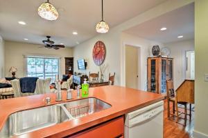a kitchen with a sink and a living room at Northwest Michigan Duplex half Mi to Lake Michigan in Charlevoix