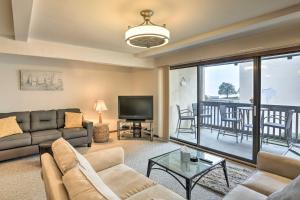 a living room with a couch and a television at The Shores Condo with Beach Access Less Than 2 Mi to Dtwn! in Port Clinton