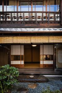 an external view of a building with a balcony at Toshiharu Ryokan in Kyoto