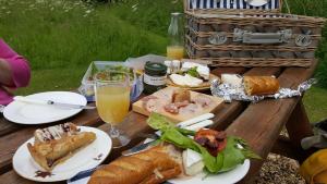 a picnic table with plates of food and drinks at Lowther House in Pickering