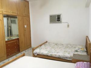 a bedroom with a bed and a cabinet and a window at El Manal 1 Private Apartment in Ain Sokhna