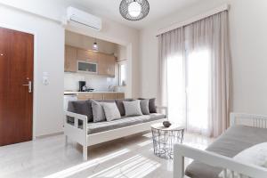 a living room with a couch and a kitchen at Helios Residence in Chania Town +19 photos