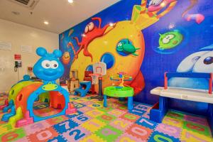 a childrens play room with a play area with a play implement at Holiday Inn Huatulco, an IHG Hotel in Santa Cruz Huatulco