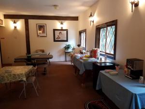 a room with tables and chairs and a laptop on a table at Kancamagus Swift River Inn in Albany