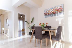 a dining room with a table and chairs at Helios Residence in Chania