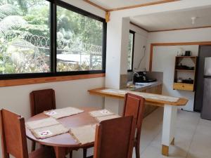 a kitchen with a table and a table and a window at Hotel El Congo in Drake