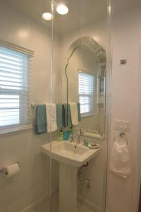 a bathroom with a sink and a shower with a mirror at Venice Beach Apartments Monthly rents in Los Angeles