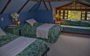En eller flere senger på et rom på Las Mercedes Lodge