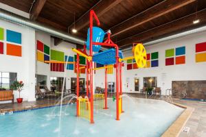 an indoor pool with a water slide in a building at Holiday Inn Express & Suites Rapid City by IHG in Rapid City