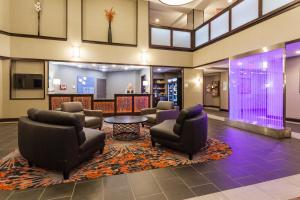 a lobby with couches and chairs and a table at Holiday Inn Express & Suites Rapid City by IHG in Rapid City
