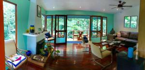 a living room with a couch and chairs at Agua Inn in Nuevo Arenal
