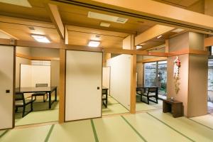 an empty room with a table and chairs at Kyonoyado Kagihei in Kyoto