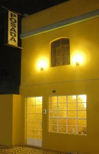 a building with two windows and two lights on it at Posada Gino in Pisco