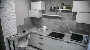 a small kitchen with a sink and a microwave at Favorite Family Flat in Bila Tserkva +29 photos