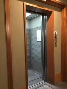 an open door to a elevator in a building at Kyonoyado Kagihei in Kyoto