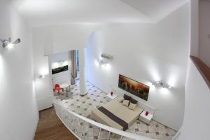 a white living room with a couch and a table at Napoli Sea in Naples