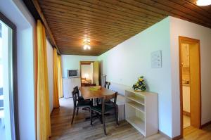 een eetkamer met een tafel en stoelen bij Appartments Kameriot in Braies
